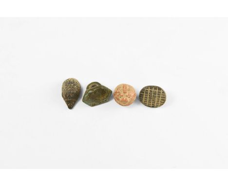 2nd millennium AD. A mixed group of pendants comprising: a ceramic stopper with cat's head detailing, pierced flange; a hexag