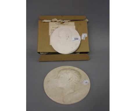 19th Century circular French porcelain plaque relief moulded with a portrait of a boy, signed J. Peyre, together with a circu