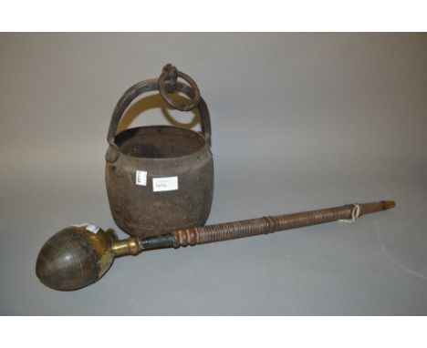 Native brass, turned wooden and nut pipe together with an iron water carrier
