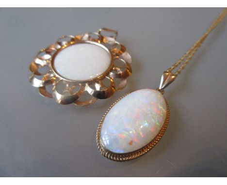 9ct Gold mounted oval opal pendant suspended from 9ct gold chain, together with another 9ct gold and opal pendant CONDITION R