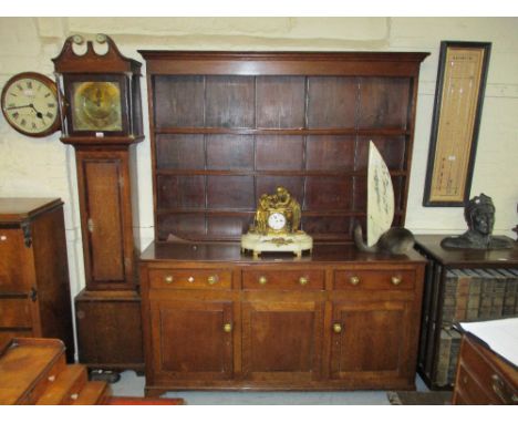 George III oak dresser, the boarded shelf back above three drawers and three cupboard doors on bracket feet, 64ins wide