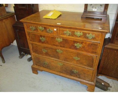 Early 18th Century figured walnut straight front chest, the crossbanded and quarter veneered moulded top above two short and 