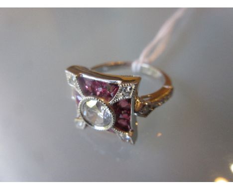 Platinum diamond and ruby ring with a central diamond of approximately 0.71ct