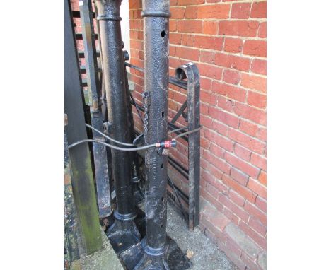 Pair of 20th Century black painted wrought iron small gates with 5.5ft posts and three heavy matching gate posts on square bo