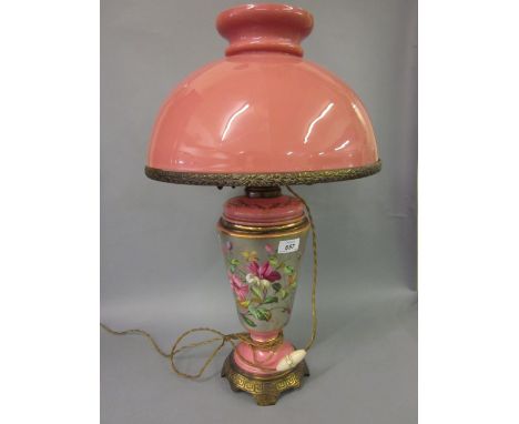 Victorian pink opaque glass oil lamp adapted for use with electricity, the body decorated with flowers together with a matchi