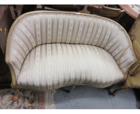 Late 19th / early 20th Century French green and gilt two seat sofa, having upholstered back and seat raised on turned taperin