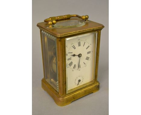 Small late 19th / early 20th Century French gilt brass cased carriage clock, the enamel dial with Arabic and Roman numerals, 