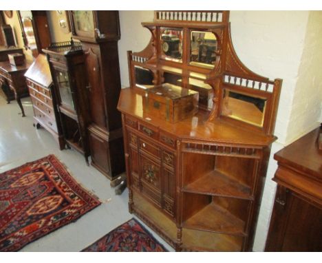 19th Century walnut Aesthetic Movement chiffonier, the shaped mirrored shelf back above a central drawer and panelled door de