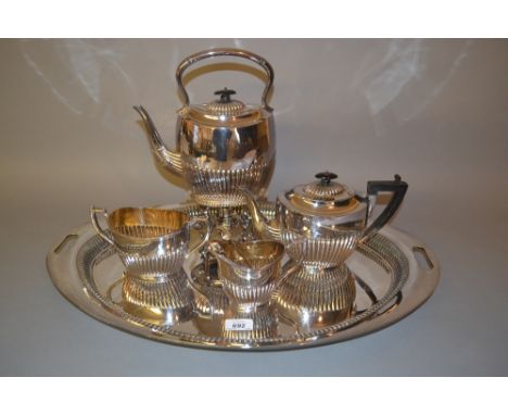 Silver plated four piece tea service including a spirit kettle and a matching oval two handled tray