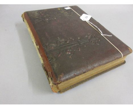 19th Century embossed leather photograph album containing a quantity of various Victorian portrait photographs
