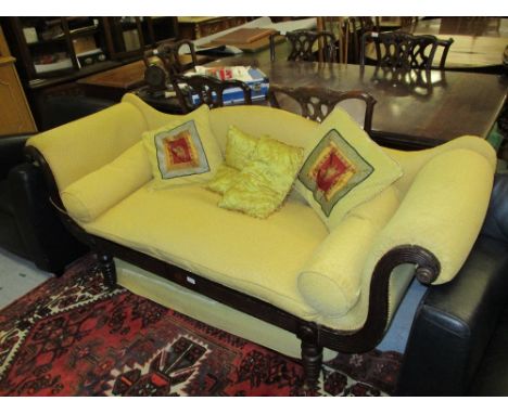 Regency stained beechwood sofa with a shaped back and scroll ends on ring turned tapering supports