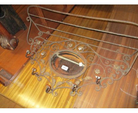 Wrought iron hat and coat rack inset with a small oval bevelled edge mirror together with a small folding wooden stool