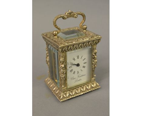 Charles Frodsham, small ornate silver cased carriage clock, the enamel dial with Roman numerals, the case London, 1978