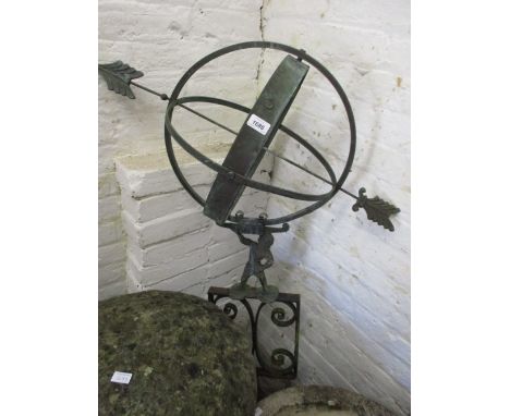 Patinated metal and wrought iron armillary sphere on a scroll work base, 15ins high overall CONDITION REPORT Height is 9.5ins