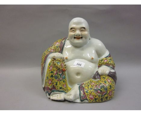 Early 20th Century Chinese porcelain enamel decorated figure of a seated Buddha, bearing character mark to base, 11.5ins high