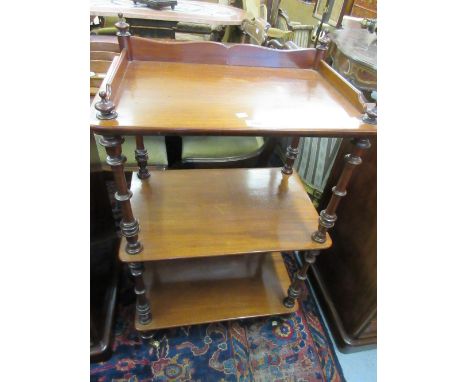 19th Century mahogany three tier whatnot having galleried top and turned supports with brass and ceramic casters