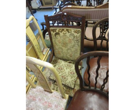 Victorian carved mahogany low seat drawing room chair with floral upholstery and turned supports with brass and ceramic caste