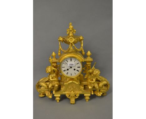 19th Century ormolu mantel clock surmounted by a floral urn with swags above a circular enamel dial with Roman numerals and t