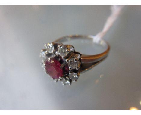 White gold ruby and diamond flower head ring CONDITION REPORT Ruby has small chips to table otherwise in good condition