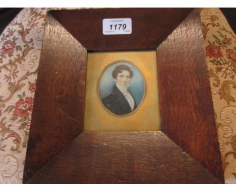 19th Century oval mounted miniature portrait of a young man in a navy blue tunic CONDITION REPORT Loss of paint to darker bla