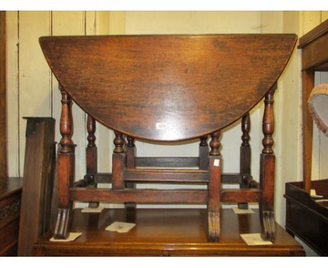 Small antique oak oval gate leg table on baluster turned supports together with a harlequin set of four 19th Century Windsor 