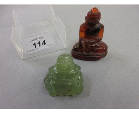 Carved amber figure of Buddha (at fault), together with a carved jade figure of Buddha