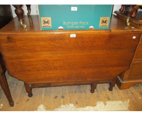 Early 20th Century oak rectangular gate leg dining table, the shaped top on barley twist supports