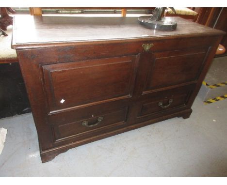 18th Century oak mule chest, the moulded hinged top above a two panel front with two drawers below raised on bracket feet