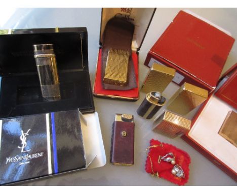 Boxed gold plated Dupont lighter, unboxed Dupont lighter, boxed Yves St. Laurent lighter and various other gold plated lighte