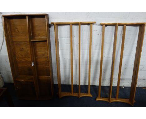 ERCOL: A pale elm hanging plate rack with panelled back and a pair of pale elm plate racks