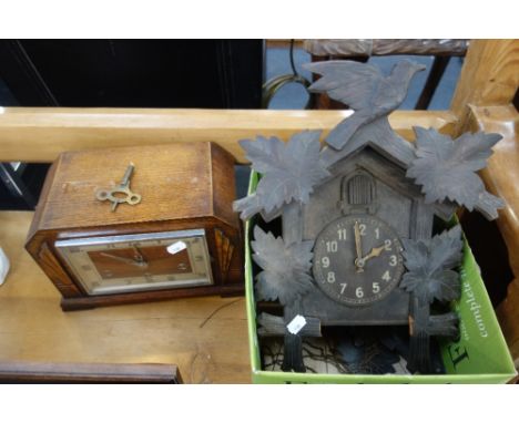 A BLACK FOREST CUCKOO CLOCK and a 1930s oak cased mantel clock