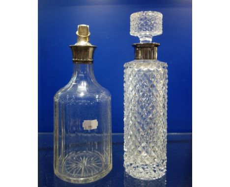 A CUT GLASS DECANTER with a silver collar and another similar (2)
