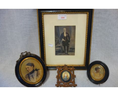A MINIATURE PORTRAIT OF A YOUNG GIRL in a Black Forest carved frame, two other printed miniatures and a framed photograph (4)