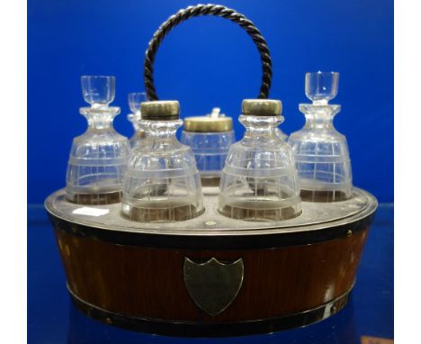 A 19TH CENTURY CRUET in a light oak stand with plated fittings, each etched glass bottle in barrel form