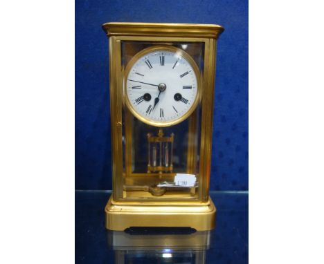 A FOUR-GLASS BRASS CASED MANTEL CLOCK, WITH MERCURY PENDULUM, CIRCULAR ENAMEL DIAL AND 'C.J &amp; Co' MOVEMENT STRIKING ON A 