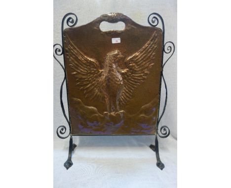 AN ARTS &amp; CRAFTS COPPER FIRE SCREEN with a wrought iron stand, 73cm high