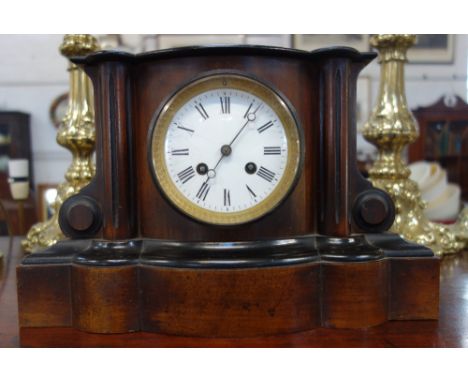 A VICTORIAN MANTEL CLOCK in a walnut and ebonised case, 21.5cm high