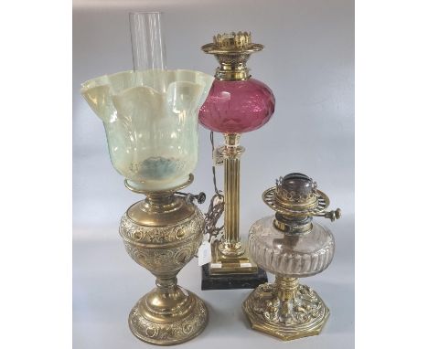 Early 20th century double oil burner lamp with frilled glass shade on a brass reservoir and base together with two other oil 