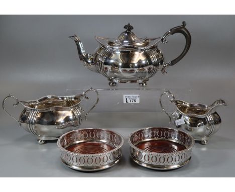 Good quality silver plated three piece tea service together with a pair of silver plated bottle coasters with turned wooden b
