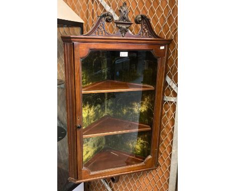 Edwardian mahogany single door hanging corner cabinet, the broken swan neck above three fitted shelves and unusual under shel