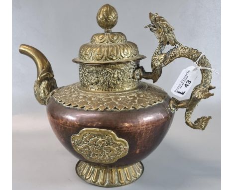 Large Tibetan brass overlay on copper 'butter-teapot' with a Makara spout and dragon handle. 27cm high approx. to the top of 