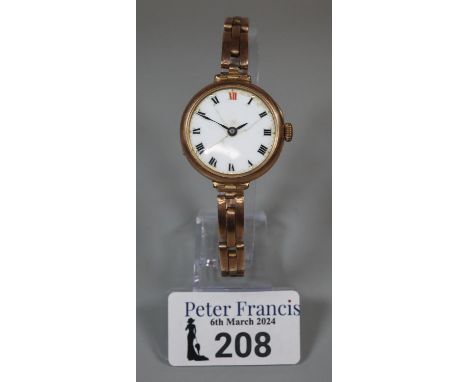 Vintage 9ct gold ladies wristwatch with ceramic face having roman numerals, on a 9ct gold expanding bracelet.  25g approx.   