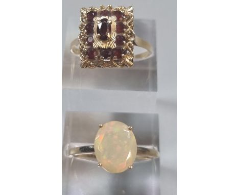 9ct gold and opalescent stone dress ring.  1.8g approx.  Size T, together with another yellow metal and garnet dress ring.  3