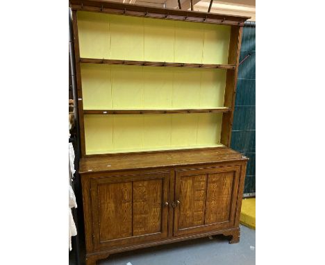 Grained/scumbled pine kitchen dresser with boarded two shelf rack back above base with two panel doors on bracket feet. 138cm