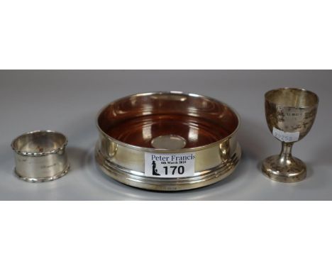 Modern silver bottle coaster, Birmingham by B & Co. with turned wooden base together with a silver napkin ring and silver egg