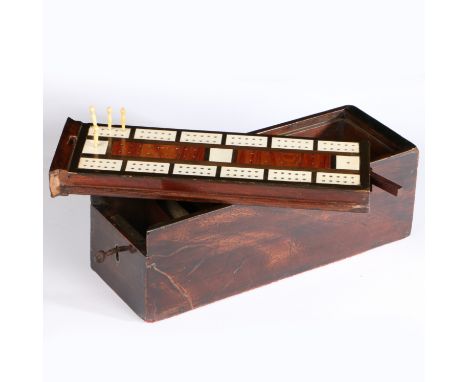 A 19th century mahogany game box, English, circa 1820-50  The underside of the sliding lid a cribbage board, inlaid with ivor