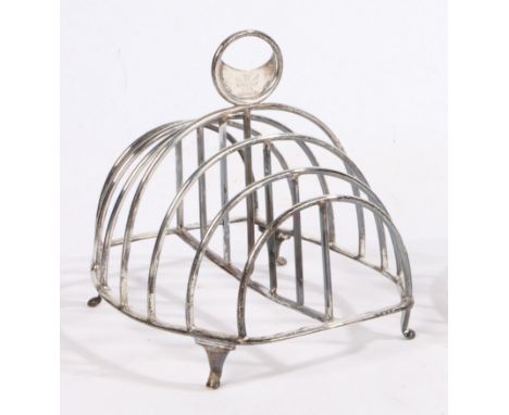 A George III silver toast rack, London 1810, maker Mary Troby, the pierced crescent handle with engraved crest above six grad