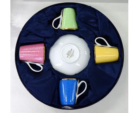 A HARLEQUIN SET OF FOUR ROYAL WORCESTER COMMEMORATIVE BUCKET SHAPED TEACUPS AND SAUCERS, GILT PRINTED MARK, BOXED 