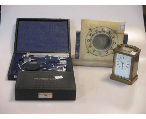 An onyx mantel clock, carriage timepiece and two opthalmoscopes (one incomplete) (4)  