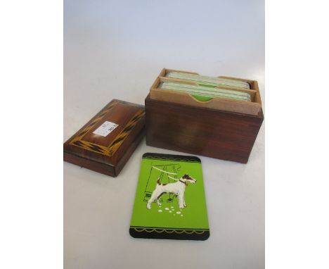 A wooden card box with Fox Terrier playing cards inside  